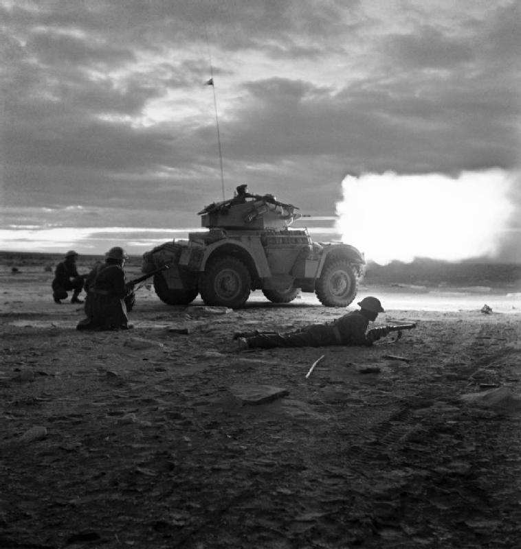 A_Daimler_armoured_car_opens_fire_in_the_gloom_of_early_morning_at_the_start_of_the_battle_for_Tripoli,_18_January_1943._E21333